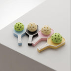 Four colorful badminton rackets with shuttlecocks on a white surface